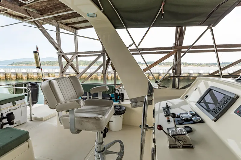 Greymalkin II Yacht Photos Pics Pilothouse interior of 2008 North Pacific 39, featuring helm and seating with waterfront view.