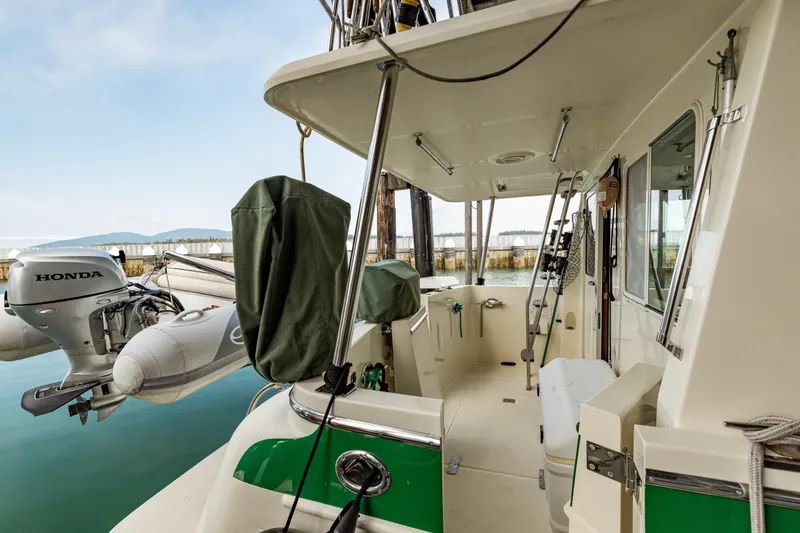 Greymalkin II Yacht Photos Pics 2008 North Pacific 39 Pilothouse boat deck with Honda outboard motor and inflatable dinghy.