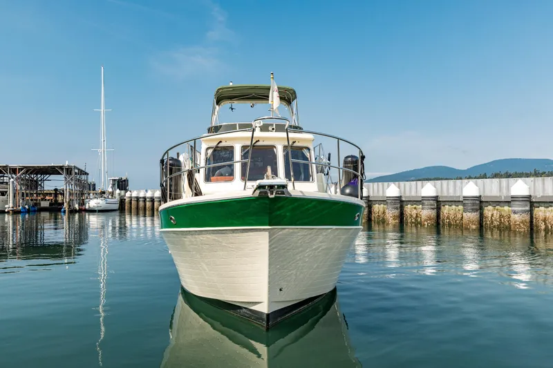 Greymalkin II Yacht Photos Pics 2008 North Pacific 39 Pilothouse boat docked in a serene marina setting.