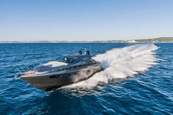  Yacht Photos Pics 2016 Pershing 62' yacht cruising swiftly on open blue sea.