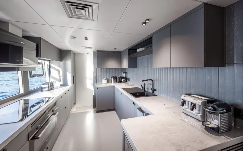 Numarine 30xp Yacht Photos Pics Modern kitchen interior on 2025 Numarine 30XP yacht, featuring sleek cabinetry and appliances.