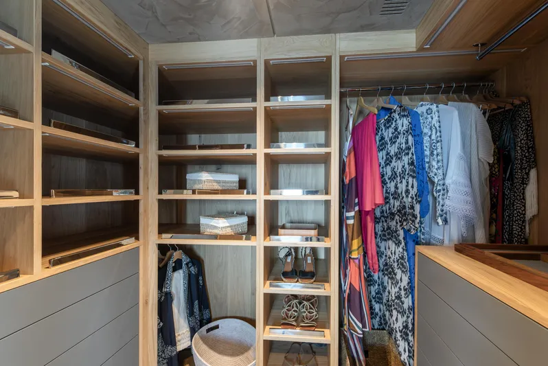 Numarine 30xp Yacht Photos Pics Walk-in closet with wooden shelves and hanging clothes on Numarine 30XP yacht, 2025 model.