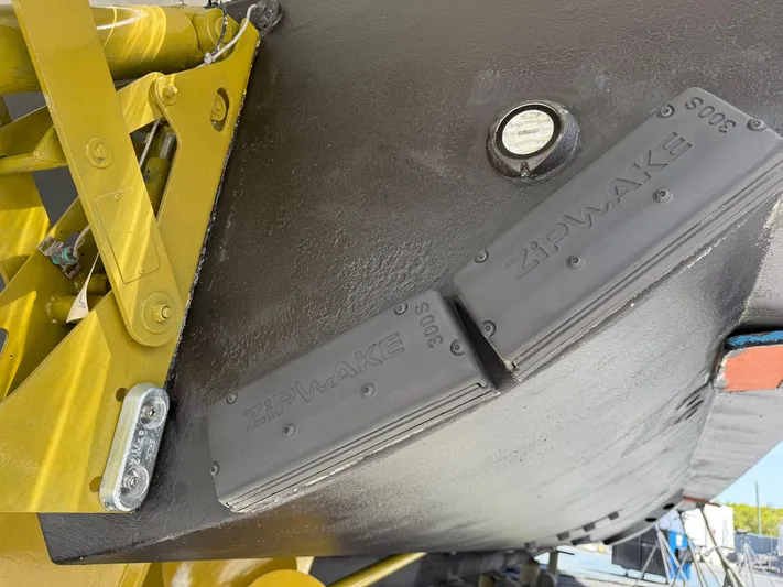 Fantasea Yacht Photos Pics Close-up of a 2020 Sirena 64 boat hull with Zipwake interceptors.