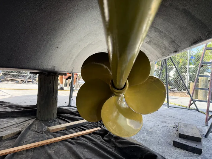 Fantasea Yacht Photos Pics Close-up of a Sirena 64 yacht's propeller, 2020 model, in a shipyard setting.
