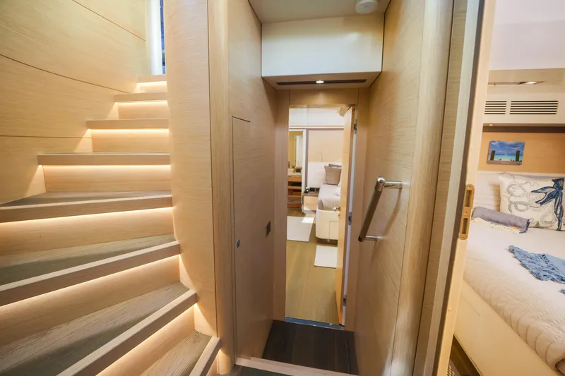 Fantasea Yacht Photos Pics Interior of 2020 Sirena 64 yacht featuring modern staircase and luxurious bedroom.