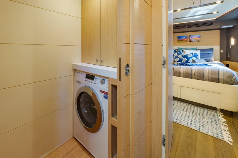 Fantasea Yacht Photos Pics Laundry area and bedroom interior of 2020 Sirena 64 yacht, featuring modern design.