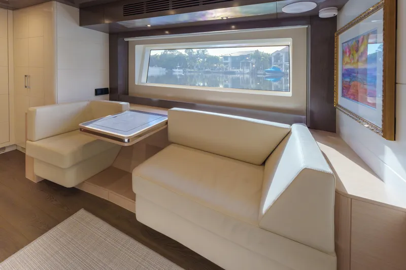 Fantasea Yacht Photos Pics Luxurious interior of 2020 Sirena 64 yacht with elegant seating and large window view.