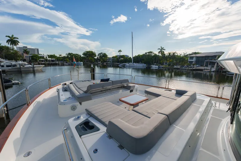 Fantasea Yacht Photos Pics Luxurious 2020 Sirena 64 yacht with spacious deck seating, docked in a serene marina.