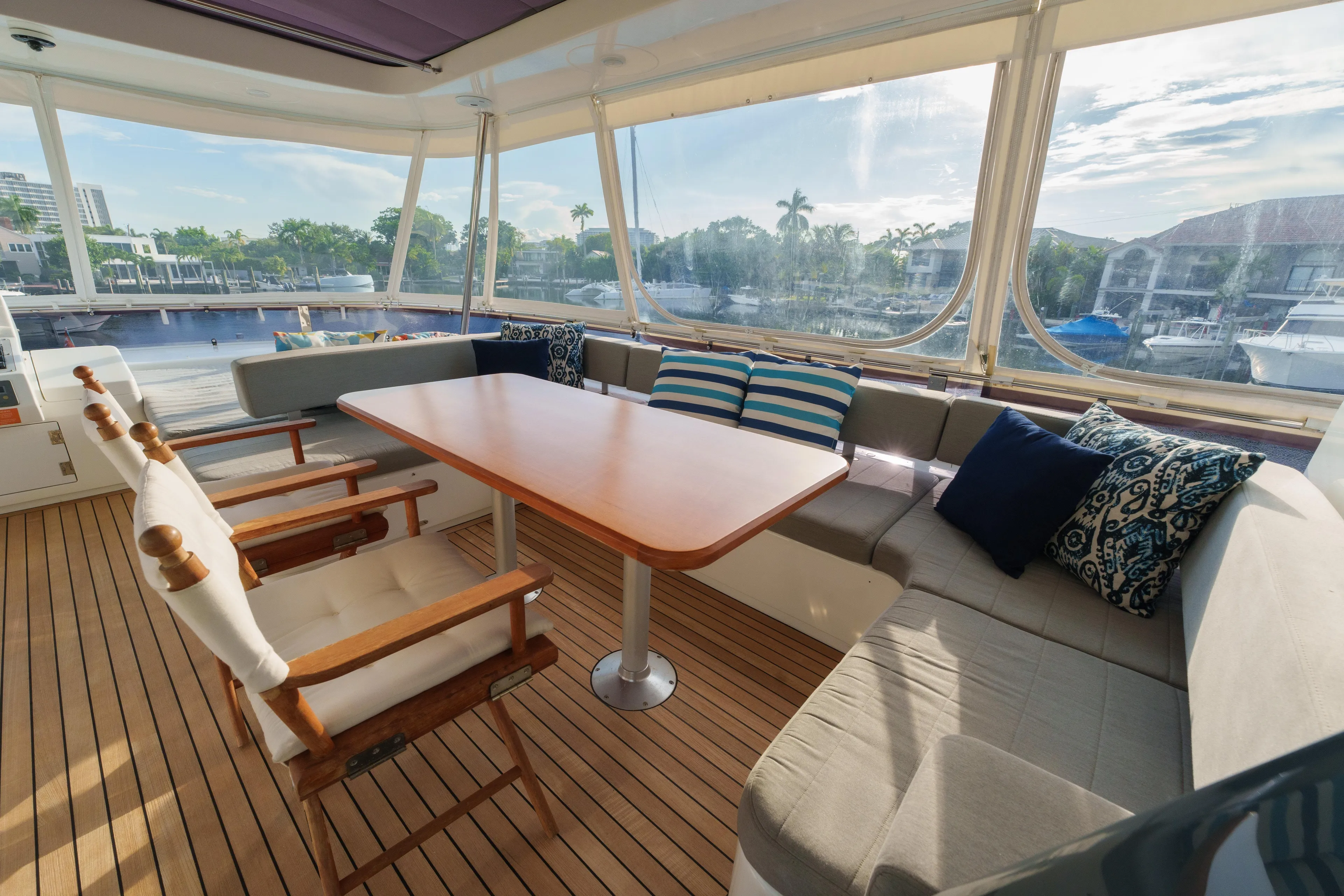 Fantasea Yacht Photos Pics Luxurious 2020 Sirena 64 yacht interior with elegant seating and scenic marina view.