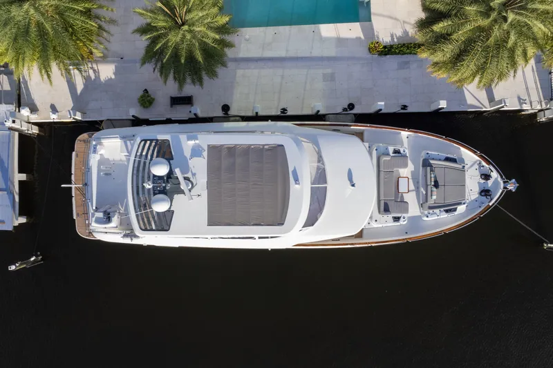 Fantasea Yacht Photos Pics Aerial view of 2020 Sirena 64 yacht docked near palm trees and a pool.