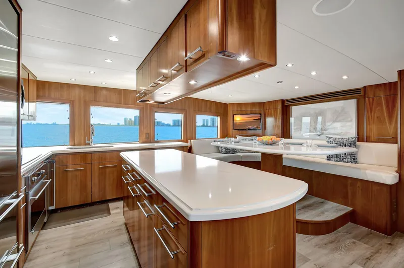 Danielle Yacht Photos Pics Luxurious 2005 Hatteras Semi-Displacement yacht interior with modern kitchen and panoramic windows.