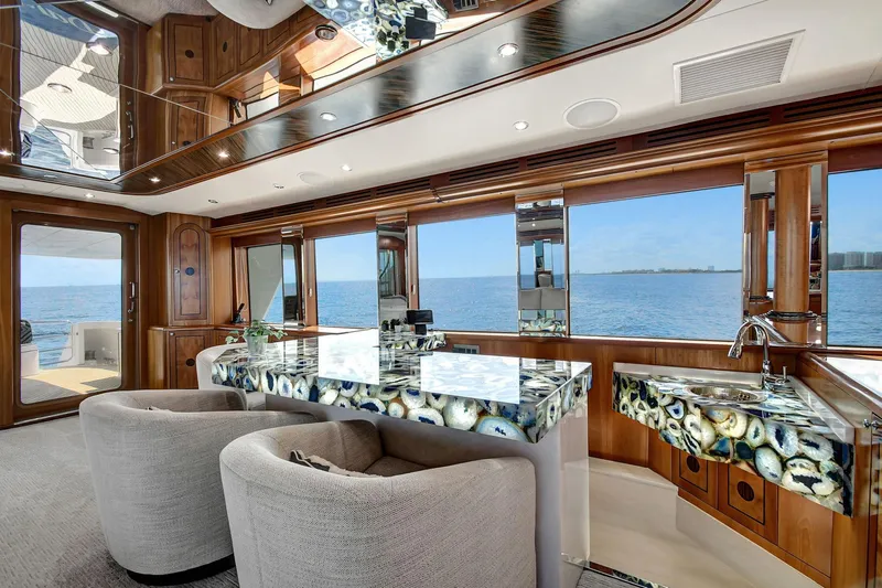 Danielle Yacht Photos Pics Luxurious 2005 Hatteras Semi-Displacement yacht interior with elegant seating and ocean view.
