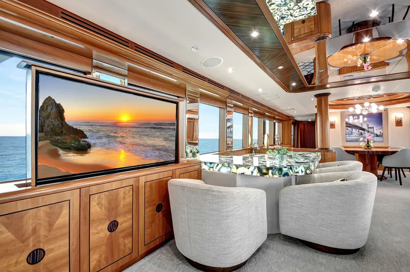 Danielle Yacht Photos Pics Luxurious 2005 Hatteras Semi-Displacement yacht interior with elegant seating and large screen.
