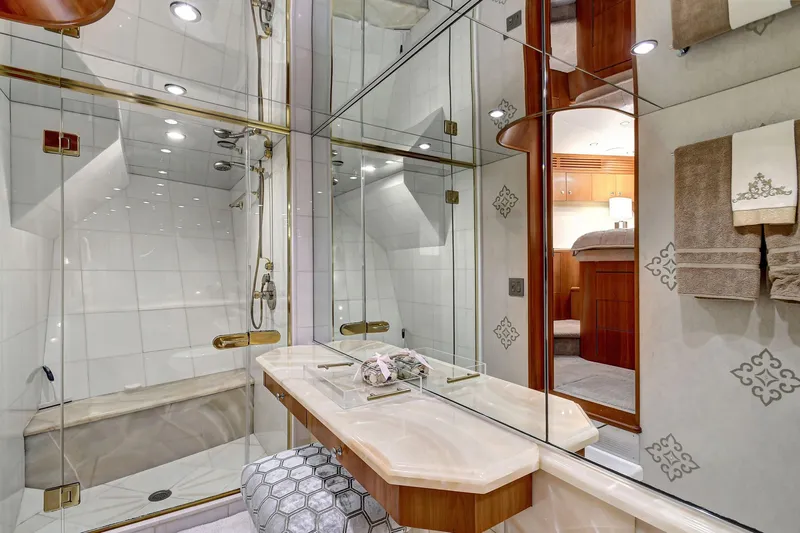 Danielle Yacht Photos Pics Luxurious bathroom in 2005 Hatteras Semi-Displacement yacht with elegant fixtures and mirrored walls.