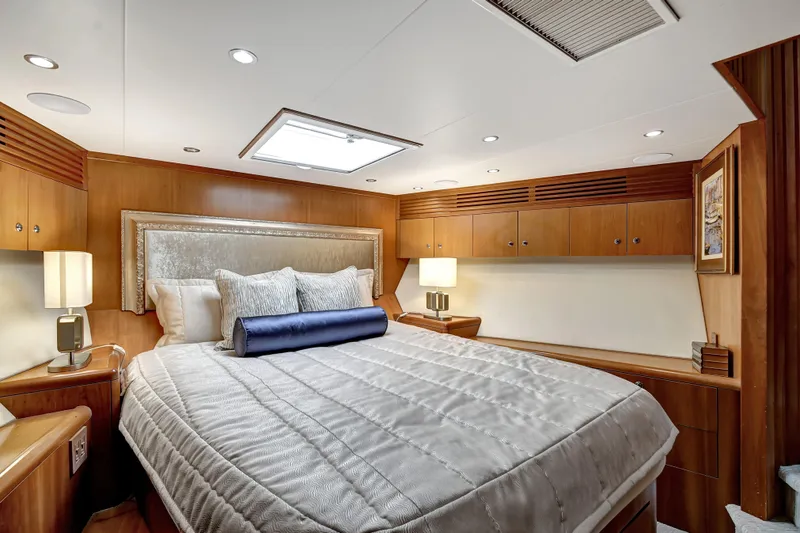 Danielle Yacht Photos Pics Luxurious bedroom interior of 2005 Hatteras Semi-Displacement yacht with elegant wood finishes.