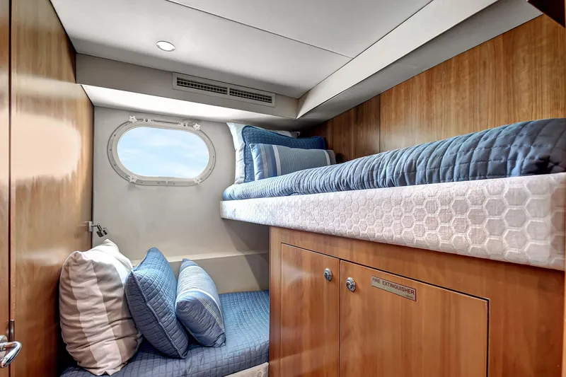 Danielle Yacht Photos Pics 2005 Hatteras Semi-Displacement yacht cabin with bunk beds and porthole window.