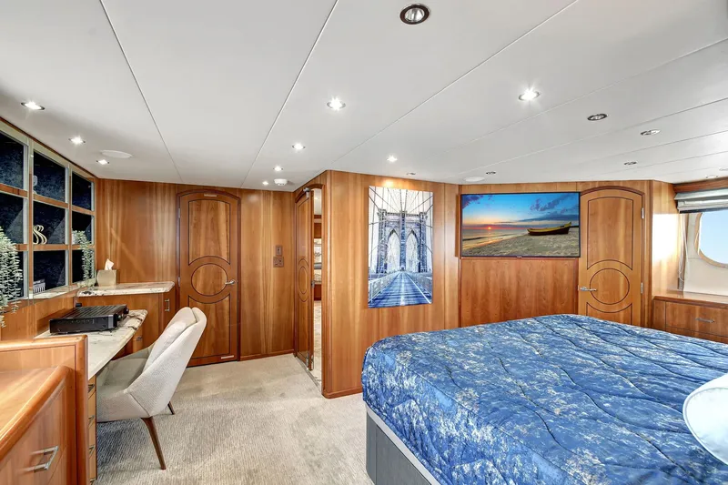 Danielle Yacht Photos Pics Luxurious 2005 Hatteras Semi-Displacement yacht bedroom with elegant wood paneling and modern decor.