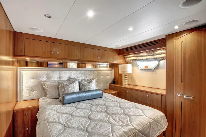 Danielle Yacht Photos Pics Luxurious bedroom interior of 2005 Hatteras Semi-Displacement yacht with elegant wood finish.