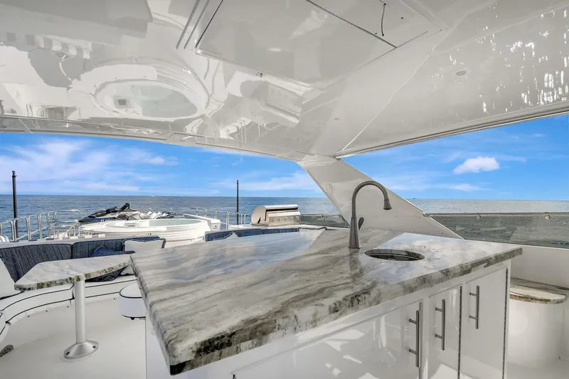 Danielle Yacht Photos Pics Luxurious 2005 Hatteras Semi-Displacement yacht with elegant outdoor bar and ocean view.