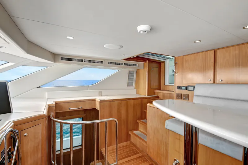Danielle Yacht Photos Pics Interior of 2005 Hatteras Semi-Displacement yacht with wooden finishes and ocean view.