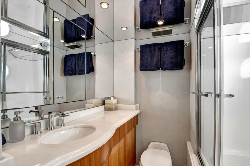 Danielle Yacht Photos Pics Luxurious bathroom in 2005 Hatteras Semi-Displacement yacht with modern fixtures and elegant design.