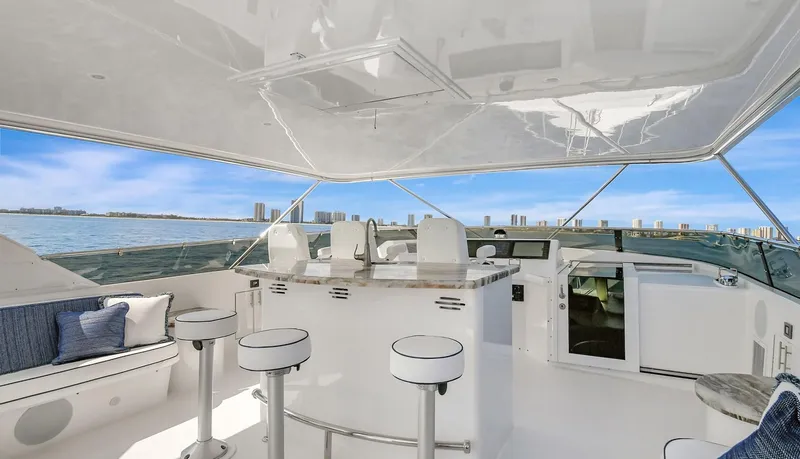 Danielle Yacht Photos Pics Luxury 2005 Hatteras Semi-Displacement yacht interior with bar stools and ocean view.