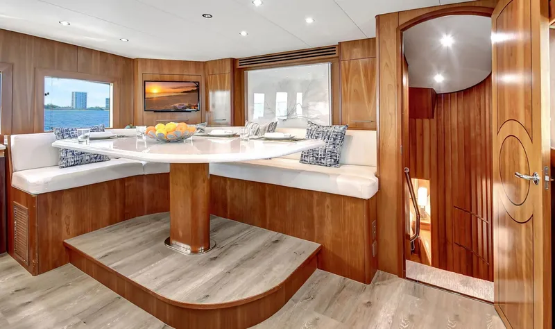 Danielle Yacht Photos Pics Luxurious 2005 Hatteras Semi-Displacement yacht interior with elegant dining area and modern decor.