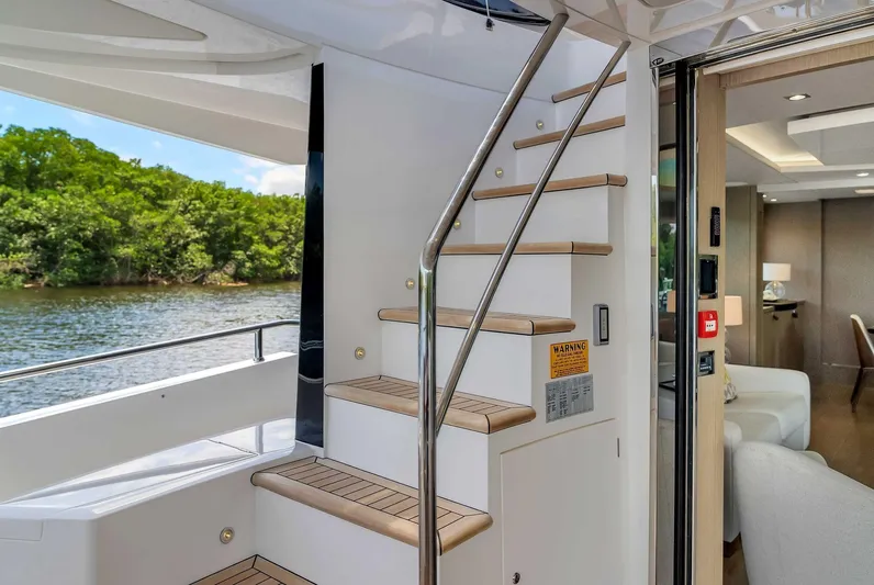  Yacht Photos Pics Interior view of 2019 Sunseeker 86 yacht with staircase and water view.