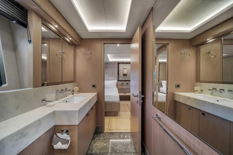  Yacht Photos Pics Luxurious bathroom interior of 2019 Sunseeker 86 yacht with modern fixtures and wood accents.