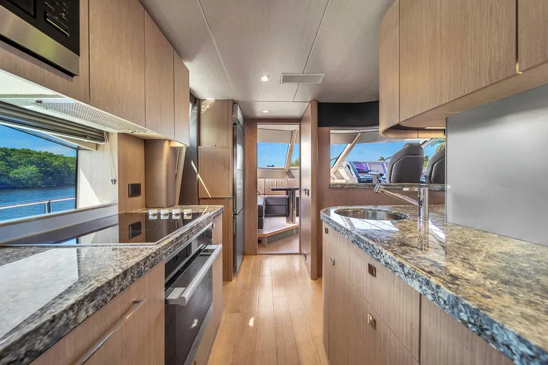  Yacht Photos Pics Luxurious interior of 2019 Sunseeker 86 yacht with modern kitchen and scenic views.