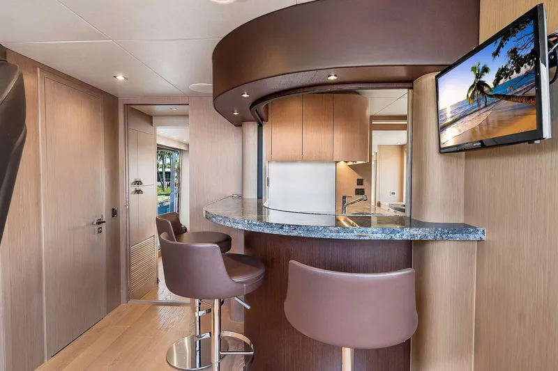  Yacht Photos Pics Luxurious interior of 2019 Sunseeker 86 yacht with modern bar and seating area.