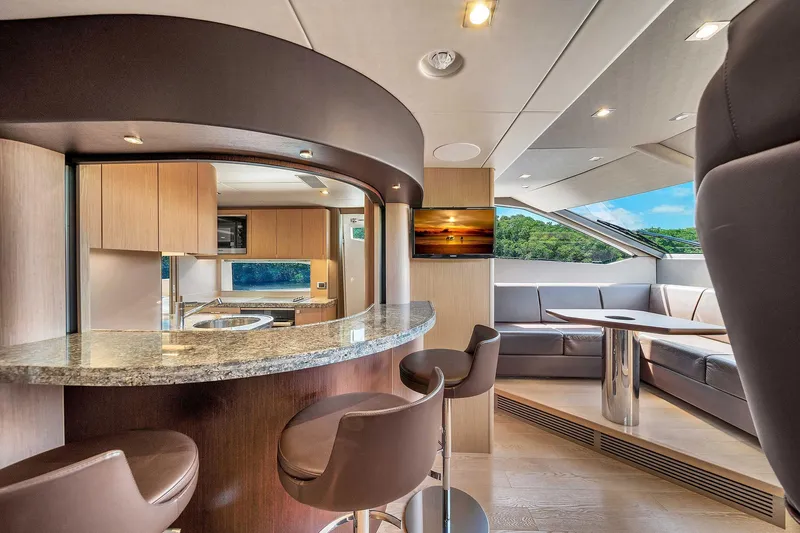  Yacht Photos Pics Luxurious interior of 2019 Sunseeker 86 yacht with modern kitchen and seating area.