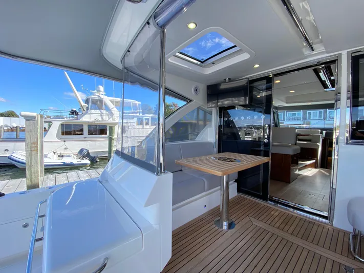  Yacht Photos Pics Luxurious 2025 Riviera 465 SUV yacht interior with sleek design and spacious seating area.