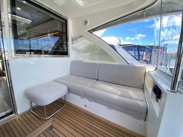  Yacht Photos Pics Luxurious interior of 2025 Riviera 465 SUV yacht with plush seating and wooden flooring.