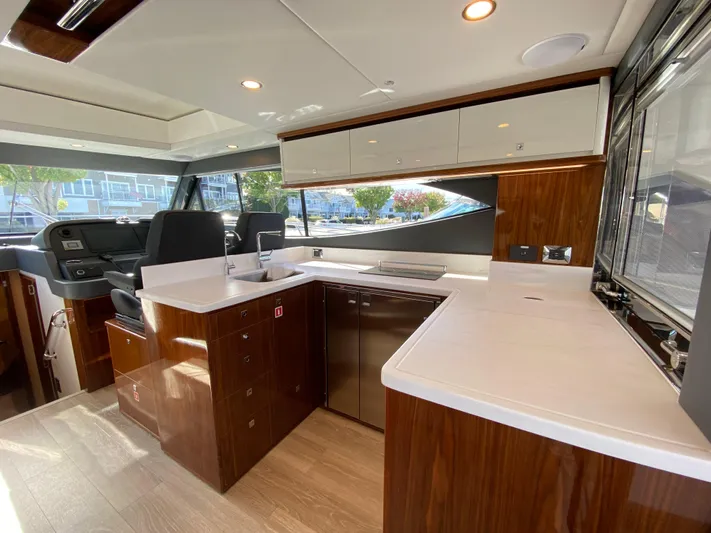  Yacht Photos Pics Luxurious interior of 2025 Riviera 465 SUV yacht with modern kitchen design.