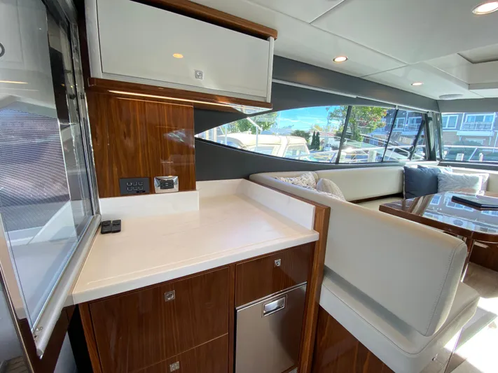  Yacht Photos Pics Luxurious interior of 2025 Riviera 465 SUV yacht with modern seating and cabinetry.