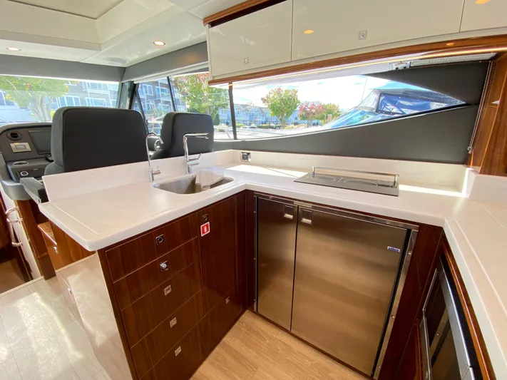  Yacht Photos Pics Luxurious interior of 2025 Riviera 465 SUV yacht with modern kitchen amenities.