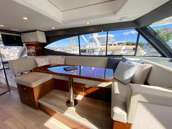  Yacht Photos Pics Luxurious interior of 2025 Riviera 465 SUV yacht with elegant seating and panoramic windows.