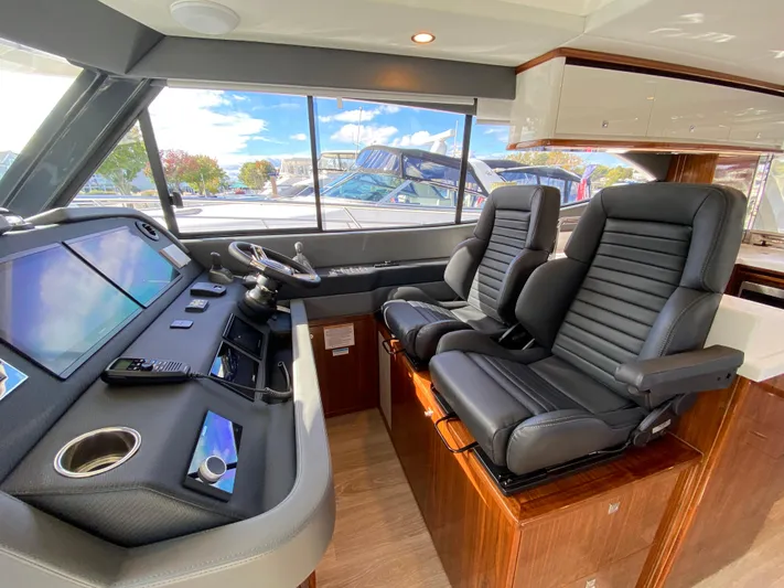  Yacht Photos Pics Interior of 2025 Riviera 465 SUV yacht with modern helm and leather seats.