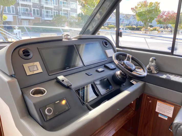  Yacht Photos Pics 2025 Riviera 465 SUV helm with modern navigation screens and controls.