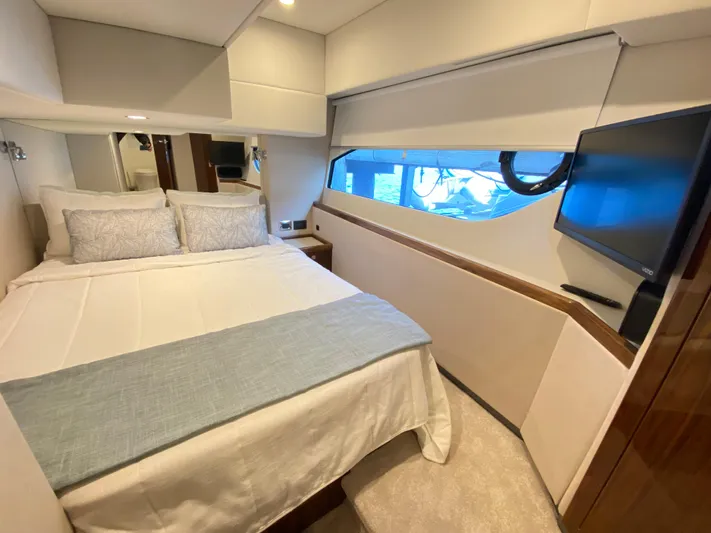  Yacht Photos Pics Luxurious bedroom interior of 2025 Riviera 465 SUV yacht with modern amenities.