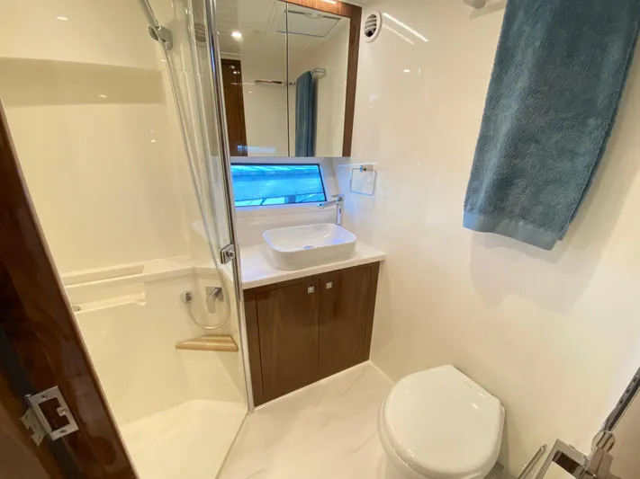  Yacht Photos Pics Luxurious bathroom in 2025 Riviera 465 SUV yacht with modern fixtures and elegant design.