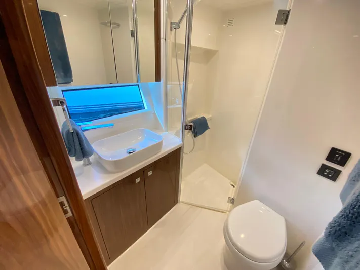  Yacht Photos Pics Luxurious bathroom in 2025 Riviera 465 SUV yacht with modern fixtures and elegant design.