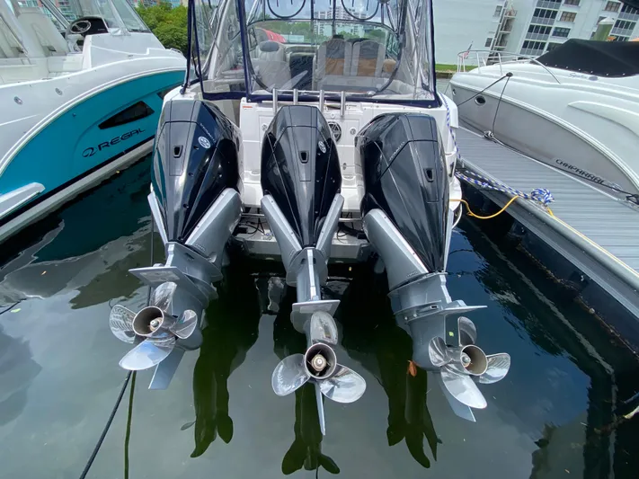  Yacht Photos Pics Three powerful outboard motors on a 2006 Four Winns 348 Vista boat docked in a marina.