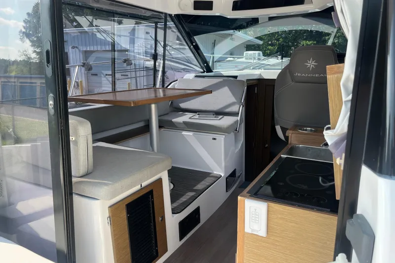  Yacht Photos Pics 2020 Jeanneau NC 895 interior with seating, table, and helm station.