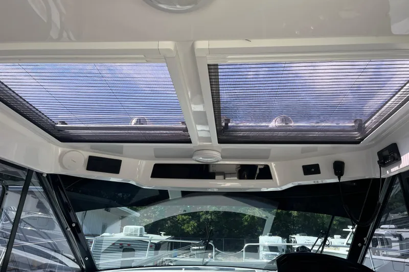  Yacht Photos Pics Interior view of 2020 Jeanneau NC 895 boat with sunroof and modern controls.