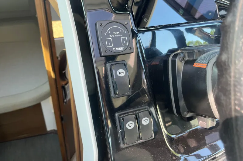  Yacht Photos Pics Control panel of a 2020 Jeanneau NC 895 boat with tank monitor and switches.
