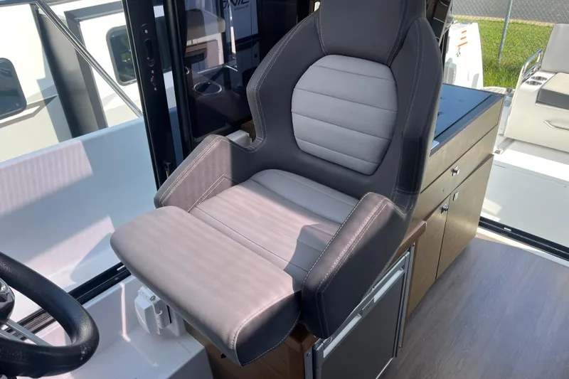  Yacht Photos Pics Captain's chair on 2020 Jeanneau NC 895 boat, featuring sleek design and comfortable seating.
