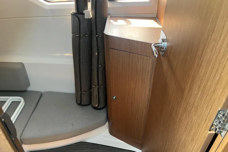  Yacht Photos Pics Interior of 2020 Jeanneau NC 895 boat, featuring wood cabinetry and seating area.