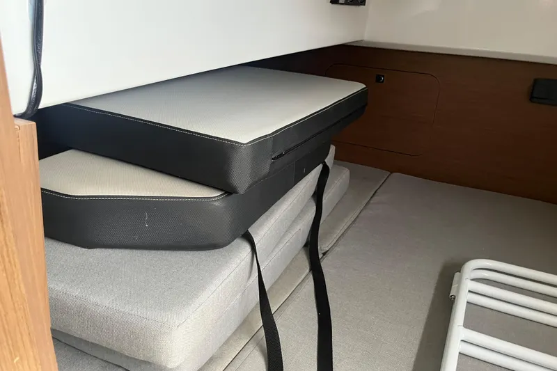  Yacht Photos Pics Interior cabin cushions of 2020 Jeanneau NC 895 boat, neatly stacked.